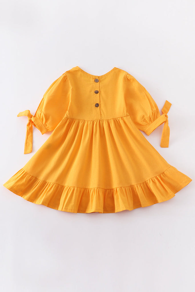 Mustard ruffle dress with bow on sleeve